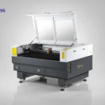 Industrial CO₂ laser cutting and engraving machine with enclosed design and lift-up lid.